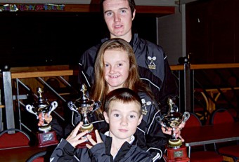 Donal, Roisin, and Conor O’Shea with their trophies after victory in the Ulster Junior Squash Open.