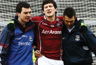 Pictured left: Galway's Michael Meehan, helped from the pitch with a injured knee after scoring a goal against Kerry on Sunday. Luckily for Galway, his injury is not as bad as first feared.
	Photo:- Mike Shaughnessy