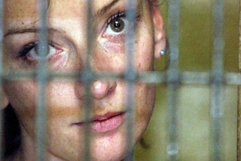 Florence Cassez of France listens as Mexican authorities fill in documentation, after her arrest in Mexico City in this Dec 9 2005 file photo. Cassez is serving a sixty-year prison sentence in Mexico for kidnapping.