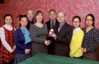 Pictured in the Threadneedle Café at The Anno Santo Hotel are Mr Xia, director of UCCCI, presenting the agreement to Shelagh Nangle, general manager of IIHCS, and Kam Chin, chairman of ICSG, along with Eamon McNamara  of the Anno Santo Hotel, local teachers Cathy Geng and Xu Jin, and UCCCI teachers Yuan Wen Feng and Jiang Fan. Photo: Mike Shaughnessy