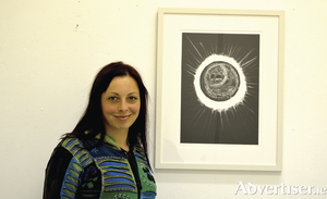 Artist Patricia Boomba with one of her works from the CODA exhibition.