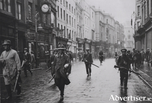 Anti-Treaty IRA volunteers patrol Grafton Street, Dublin, 1922, during the Irish Civil War.