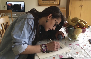 Artist Claire Talbot puts the  finishing touches to a print. Photo:- Grainne Galvin