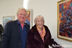 Patrick McCabe and Ann Kelly at the Atlantic Crossings Art Exhibition admiring the work of Patricia Byrne.
