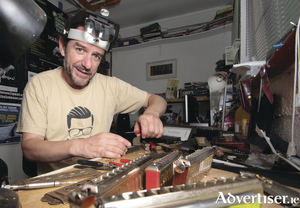 Cathal Johnson, harmonica player, in his workshop where he repairs the instruments. Photo: Mike Shaughnessy.