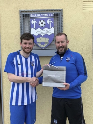 Five goal hero: Dylan Edwards was awarded the Ballina Town man-of-the-match award after he bagged five goals for his side last weekend is presented with his prize by Kieran O&#039;Malley. Photo: Ballina Town Facebook
