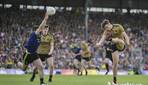 Up and over: David Clifford gets a shot off despite the efforts of Brendan Harrison. Photo: Sportsfile 