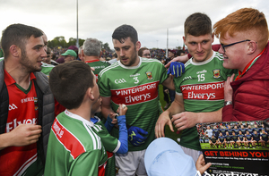 On the road again: Brendan Harrison and James Carr with Mayo fans after last weekends win over Donegal. Photo: Sportsfile