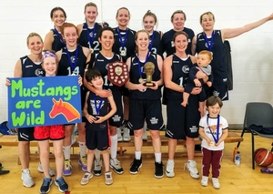 Joyous Mustangs after their victory in Drogheda Basketball Invitational last weekend:  Back row: Niamh O&rsquo;Leary, Jenna Howe, Catriona White, Ellie White, Aedin Nic Flannchadha, Siobhan Kennedy. Front row: Ciara Griffin, Ciara Curran, Karen Mulherin (Captain), Siobhan Kilkenny, Sinead Hughes with top fans, Scout and Gracie-Bell Hussey and Realta and Faolan Loftus.  