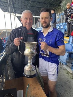 Tooreen captain Stephen Coyne is presented with the TJ Tyrell Cup. Photo: Mayo GAA 