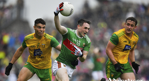 Holding on: Patrick Durcan tries to hold onto the ball under pressure from Odhran McFadden Ferry in the Super 8 meeting between Mayo and Donegal last August. Photo: Sportsfile 
