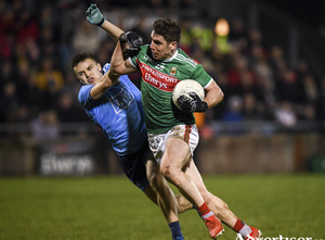 Driving on: Lee Keegan drives past Eoin Murchan last Saturday night in MacHale Park. Photo: Sportsfile 