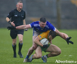 Referee Austin O&#039;Connell watches as Milltown&#039;s John Martin tries to halt Corofin&#039;s Liam Silke in the Claregalway Hotel Senior Football Championship game at Tuam Stadium on Sunday. 
Photo:- Mike Shaughnessy