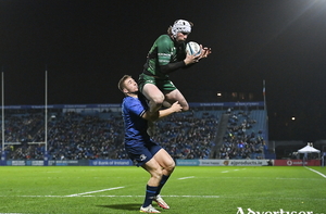 Leap of faith: Mack Hansen of Connacht catches the ball ahead of Leinster&#039;s Jordan Larmour on his way to scoring his side&#039;s first try during the URC match between Leinster and Connacht at the RDS Arena in Dublin. Photo by Ramsey Cardy/Sportsfile