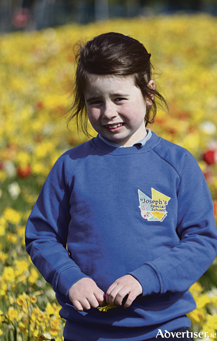 St. Joseph’s Special School on Thomas Hynes Road in Newcastle, has launched a new uniform for their school. Set against the flowers on Thomas Hynes Road, Holly wears the Junior school uniform which features a new school logo designed by Marcus Seoighe.