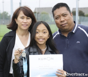 Maeve Centeno, maths silver medallist, with her parents Berna and Marte at the Kumon Awards ceremony. Photo: Mike Shaughnessy.