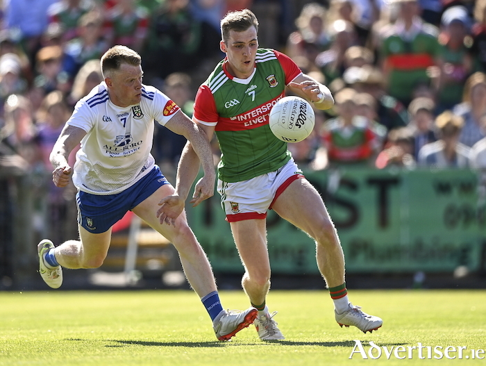 Eyes on it: Eoghan McLaughlin keeps his eye on the ball despite the attention of Ryan McAnespie last Saturday. Photo: Sportsfile. 