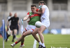 Eyes on it: Jason Doherty keeps his eye on the ball despite the close contact from Kildare&#039;s Shea Ryan. Photo: Sportsfile. 