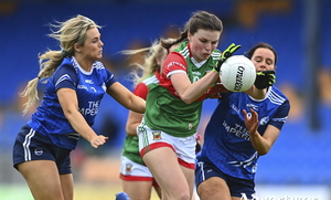 Aoife Geraghty of Mayo gets through the challenges of Mona Sheridan, left, and Annie Deneher of Cavan during the TG4 All-Ireland SFC Group A Round 2 match between Cavan and Mayo at Glennon Brothers Pearse Park in Longford. Photo by Ben McShane/Sportsfile