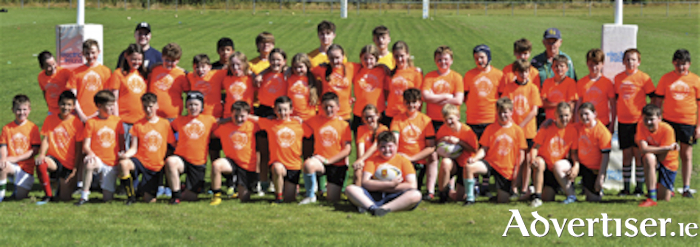 Boys and girls who participated in the recent Smith’s Super Valu rugby summer camp at Buccaneers are pictured with USA international player, Luke Carty and club coach, Charlie Couper