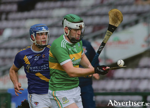 Loughrea&#039;s Anthony Burns keeps the pressure on Gort captain Aiden Helebert in action from the Brooks Senior Hurling Championship game at Pearse Stadium on Saturday. Loughrea finished the game 10 point ahead Gort. Photo:- Mike Shaughnessy
