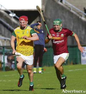 Craughwell&#039;s Thomas Monaghan is chased by Gort&#039;s Richie Cummins in the Brooks Galway Senior Hurling Championship at Pearse Stadium on Sunday. Craughwell ran out 10-point winners with a score of 4-16 to 1-15.Photo:- Mike Shaughnessy