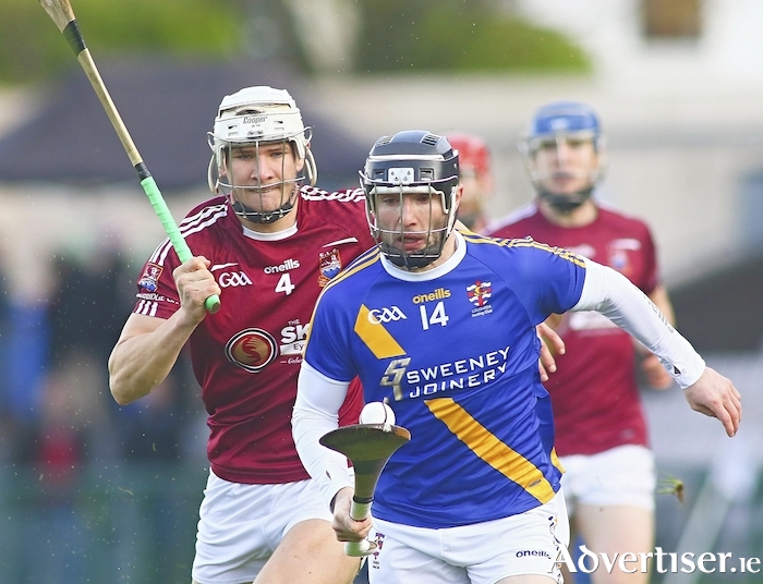 Jamie Ryan of winners Loughrea is chased by Oisín Salmon, Clarinbridge, in the Brooks Senior Hurling Championship semi-final at Pearse Stadium on Sunday. Photo:- Mike Shaughnessy