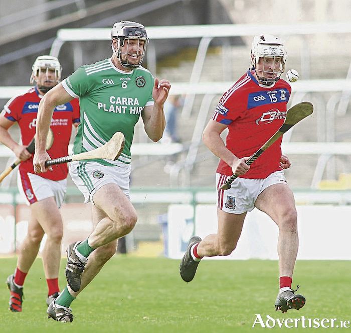 Eye on the final: St Thomas' forward Oisin Flannery is chased by Sarfields' Joseph Cooney in the Brooks Senior Hurling championship semi-final at Pearse Stadium on Sunday. St Thomas' won 2-19 to 15. Photo:- Mike Shaughnessy