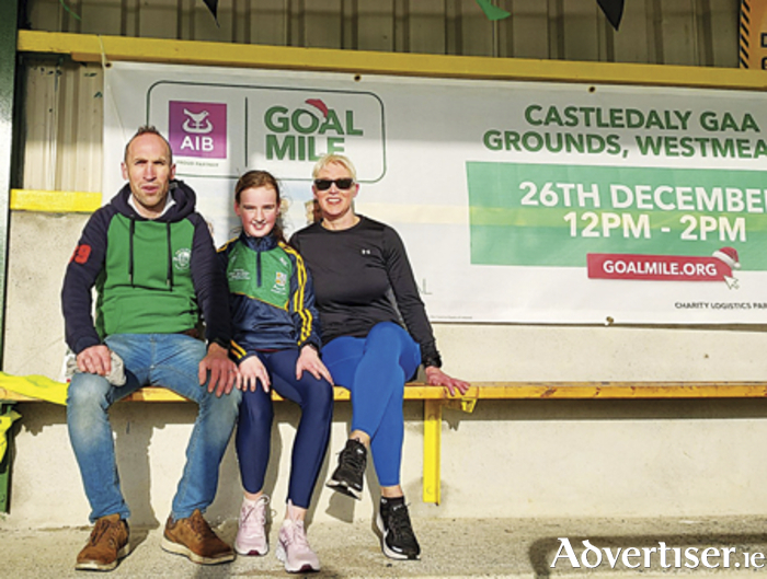 Former Castledaly footballer, Ciaran Henson, is pictured with his daughter Niamh and sister, Eilish, during the GOAL Mile fundraising initiative which took place at Castledaly GAA grounds