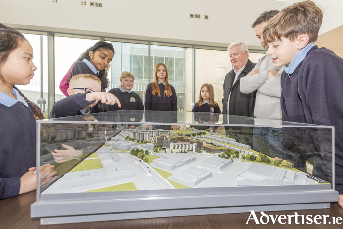 Students from Radharc na Mara NS look at  a scale model of the Crown Square development.