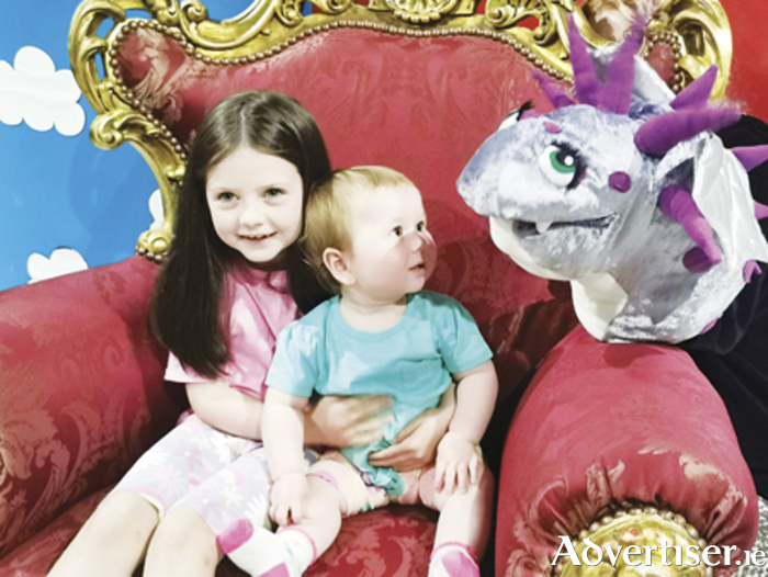 Holly and Sophie Joyce are pictured with Smokie the Dragon at the children's book reading in Athlone Castle
