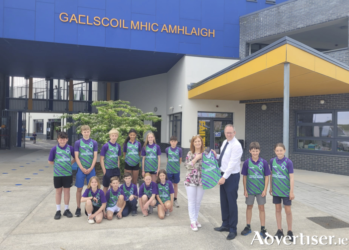Claddagh Credit Union are proud to present Gaelscoil Mhic Amhlaigh with a brand new set of singlets for all the sporting events the school take part in. Gaelscoil Mhic Amhlaigh has a strong tradition in athletics and competes in the City Sports and Cross Country events held locally in Galway.  They have up to 40 students competing in these events as well as competing in local basketball competitions. Pictured here is Deputy CEO Ted Coyle & Príomhoide Dairíona Nic Con Iomaire & some of the students of the Gaelscoil.
