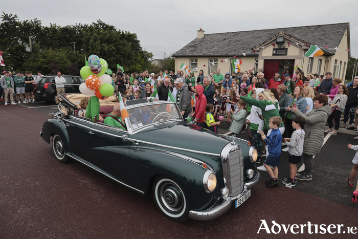 Special Olympic medal winning gymnast Marie Connolly, Clarinbridge with her parents Mike and Ber in a 1952 vintage Mercedes driven by Dermott Crombie who drove her to a homecoming celebration reception in Clarinbridge on Monday night make their way through Carty’s Cross . 
Photo: Mike Shaughnessy 
