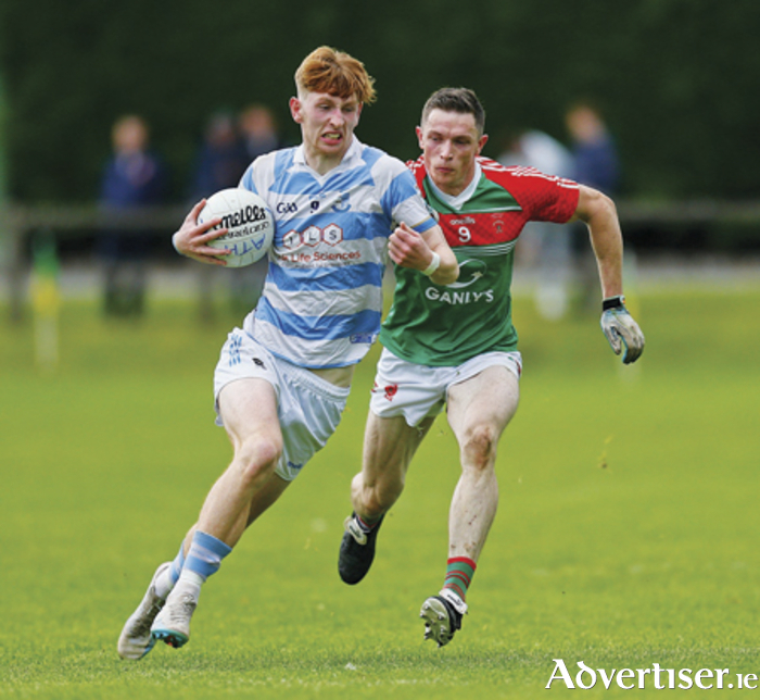 Athlone’s Ben Killian evades the clutches of Garrycastle’s Conor McKiernan during Saturday evening’s Westmeath senior football championship encounter in Tubberclair.  Athlone won by two points to advance to the quarter final stage of the competition.  Photograph by Ashley Cahill Images.