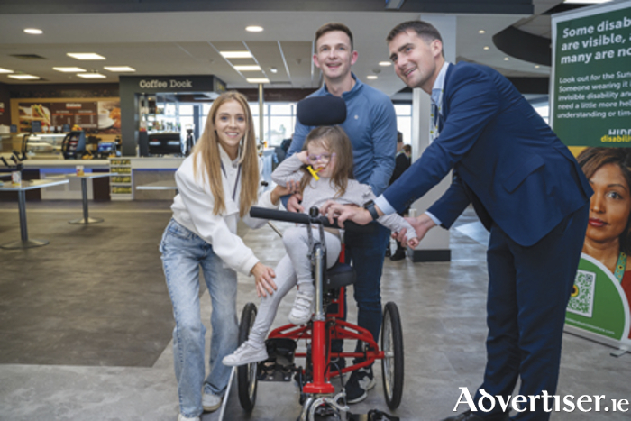 Athlone’s Jade McCallon is pictured receiving her special mobility trike from Minister Jack Chambers at Ireland West Airport.  Also pictured are Jade’s parents, Denise and Mark.