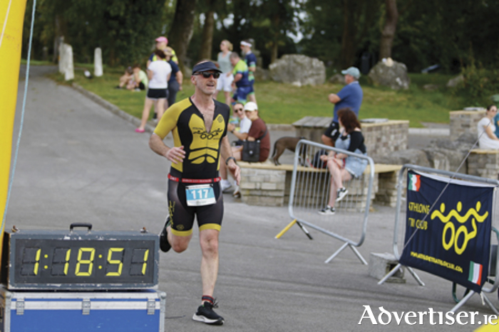 Brendan Doyle from Athlone Triathlon Club crosses the finish line during the Lough Ree Monster Triathlon in Coosan Point on Saturday.  Pic by Ashley Cahill Images.
