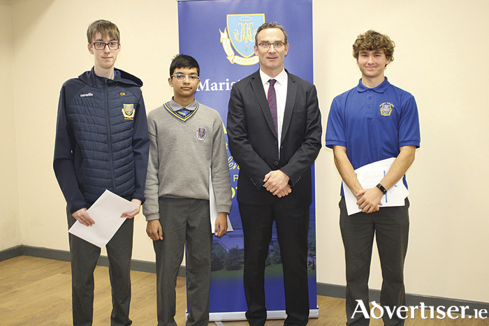 Charles Rayner, Hamzah Mateen and Barra Powell are pictured with Marist College principal, Mr Dermody, as they received their Junior Certificate results.

