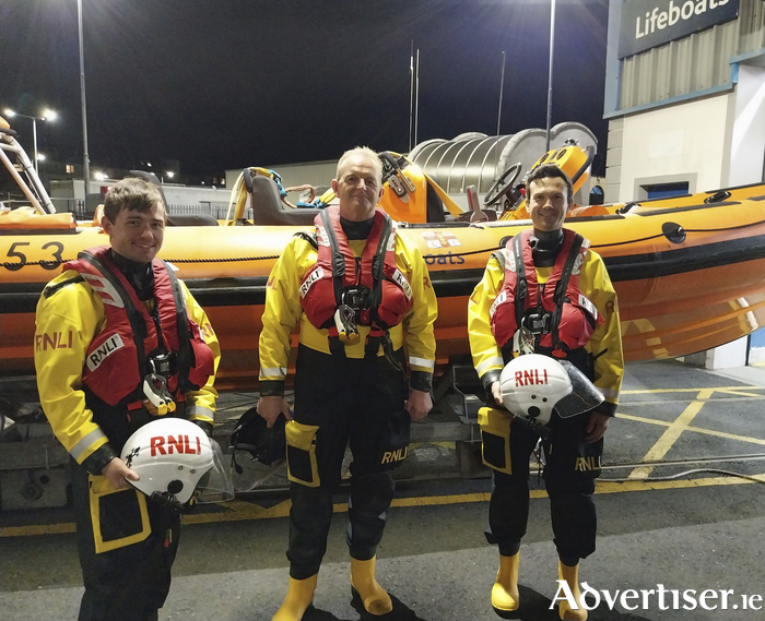 Galway RNLI volunteer crew Aaron O’Reilly (left) and James Corballis (right) after completing and passing the last of their assessments afloat which means that they can become fully-fledged crew, with RNLI assessor trainer Sean Ginnelly (centre).