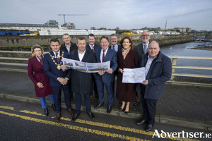 Phelim O&rsquo;Neill, Head of Property, Land Development Agency, and Minister for Housing, Local Government and Heritage Darragh O&rsquo;Brien TD (centre)  at Galway Harbour alongside local politicians and representatives from the Galway Harbour Company and Galway City Council to announce the transfer of a 3-acre Galway Harbour site, with potential for more than 250 homes, to the LDA. 
Photo Andrew Downes