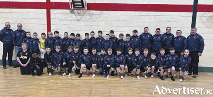 Seamus King of Forefront Events, who is based in Australia and is a former player with Garrycastle, presented training tops to the Garrycastle Under-12 boys playing squad and management