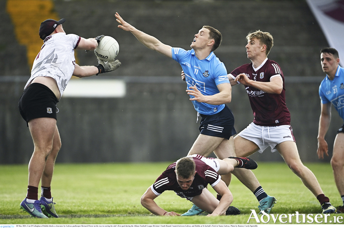 Con O'Callaghan of Dublin blocks a clearance by Galway goalkeeper Bernard Power on his way to scoring his side's first goal during the Allianz Football League Division 1 South Round 3 match between Galway and Dublin at St Jarlath's Park in Tuam, Galway. Photo by Ramsey Cardy/Sportsfile