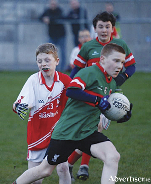 Garrycastle&#039;s Harry Killion drives forward with the ball, supported by Jason Doolan, during the club&#039;s recent Under-12 league match against Coralstown/Kinnegad 