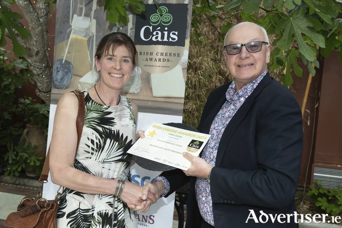 Portumna-based Farmhouse Cheesemaker, Marion Roeleveld (left), of Killeen Farmhouse Cheese, being presented with the Gold award in the ''Hard Cheese (Flavour Added)' category at the 2024 Irish Cheese Awards by broadcaster and MC for the event, Bobby Kerr (right)