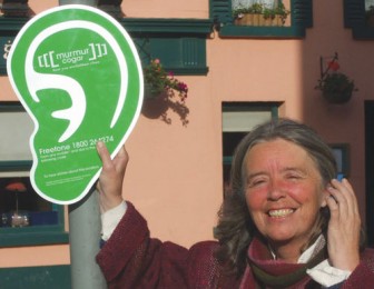 Story collector and writer Máire Holmes tries out [murmur] on her mobile.