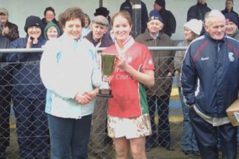 Sarah Noone, captain of Ahascragh-Caltra camogie team, receiving the cup from Geraldine McGrath after winning the Intermediate Connacht final on Sunday against Four Roads of Roscommon.