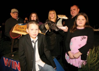 Marie O'Connell presents the winning trophy to her husband Denis O'Connell after Mardoc O'Shea had captured the Mardoc Holdings Golden Jacket Classic final at the Galway Greyhound Stadium. Also in photo are trainer Francis O'Donnell, handler Jennifer O'Donnell, and Cian and Cara O'Connell. Photo. Iain McDonald.