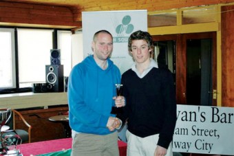 John Rooney receiving his prize from tournament director Edwin Brennan.