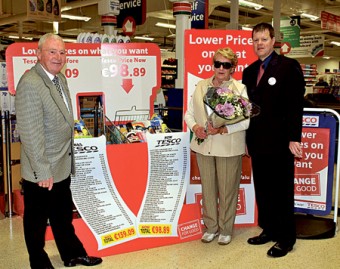 Joy and John Flannelly from the Curragh, Castlebar who officially reopened the Tesco Castlebar store, were presented with a bouquet by Seamus McGowan, store manager. Photo: Ken Wright Photography 2009.