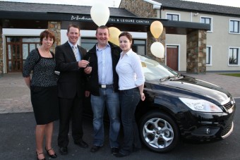 Geraldine Padden (proprietor, Broadhaven Bay Hotel), and David Tyrell (manager, Broadhaven Bay Hotel) hand the car keys to Mark Connor and Karen O&rsquo;Sullivan. 