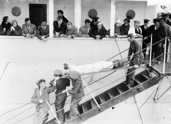 One of the survivors being lowered to the deck of the tender